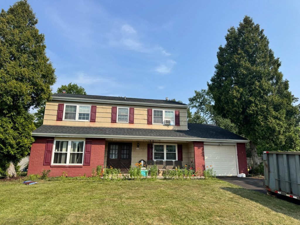 Two-story home with a new shingle roof by DMS Contractors