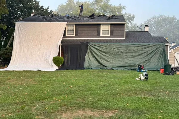 Home protected with tarps during roof repair